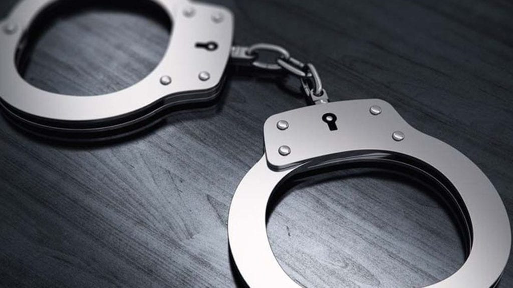 A pair of handcuffs on top of a table.