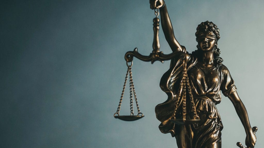A statue of lady justice holding the scales.